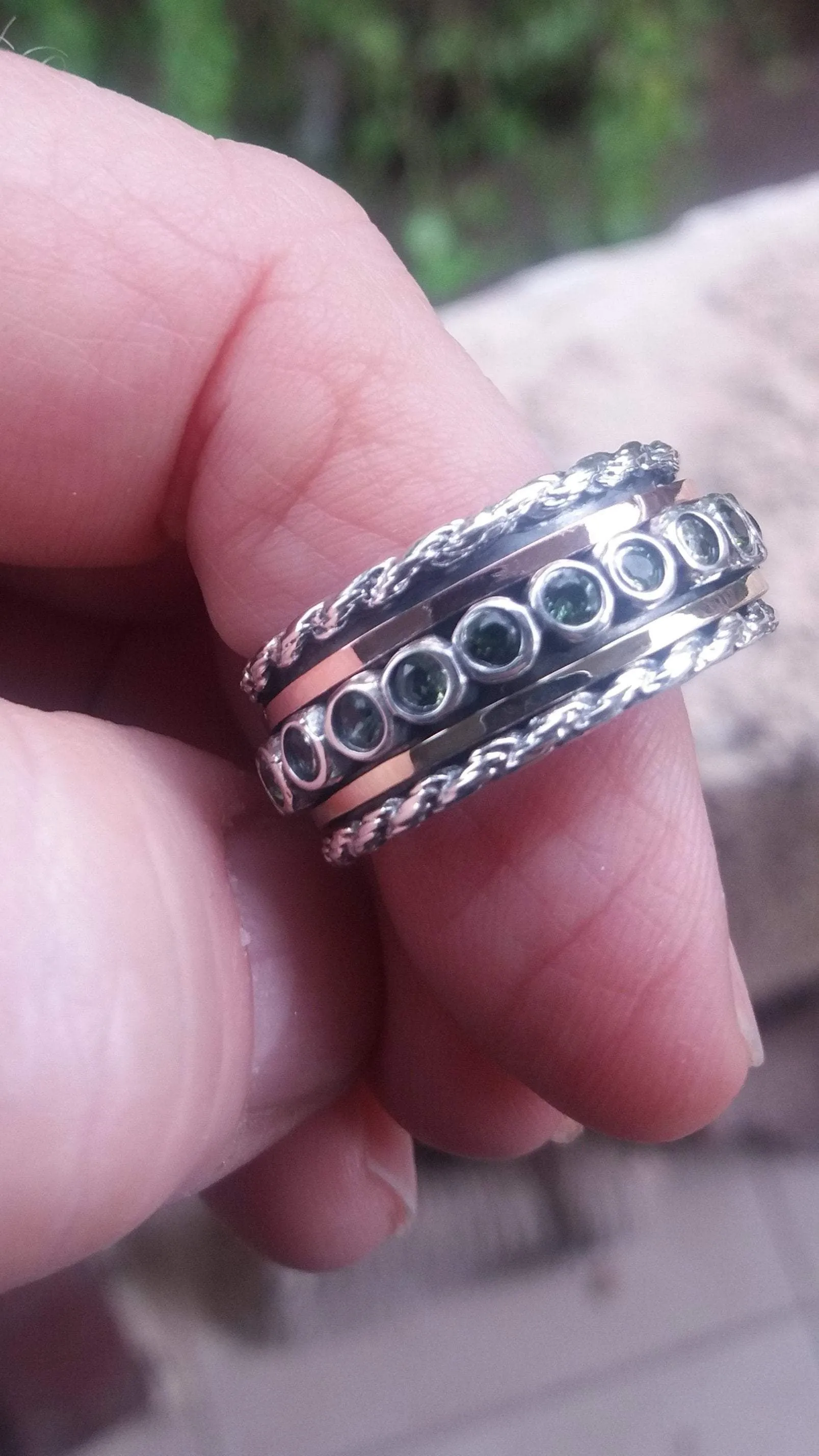 Spinner ring for woman Sterling silver and gold set with green Tourmalines.